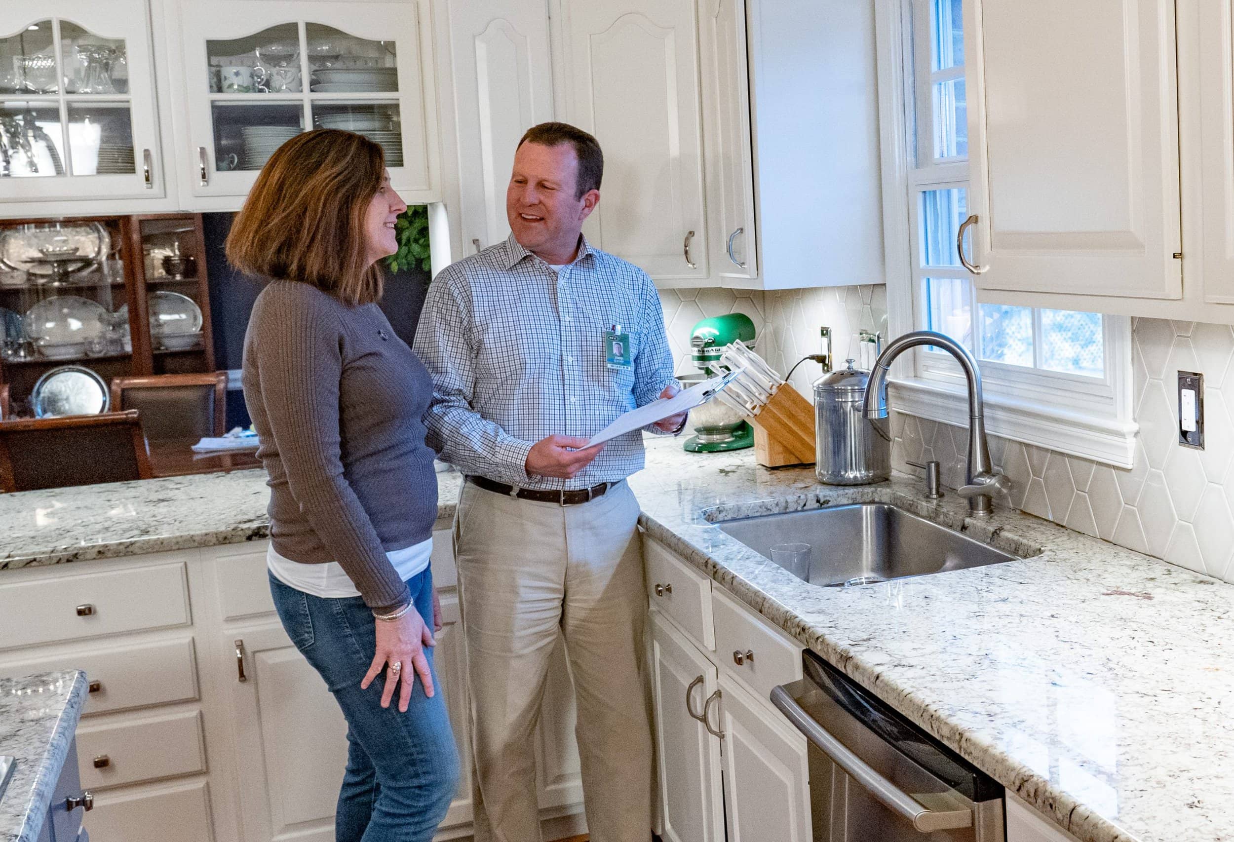 HEC employee reviewing home energy audit with Harrisonburg resident in their kitchen